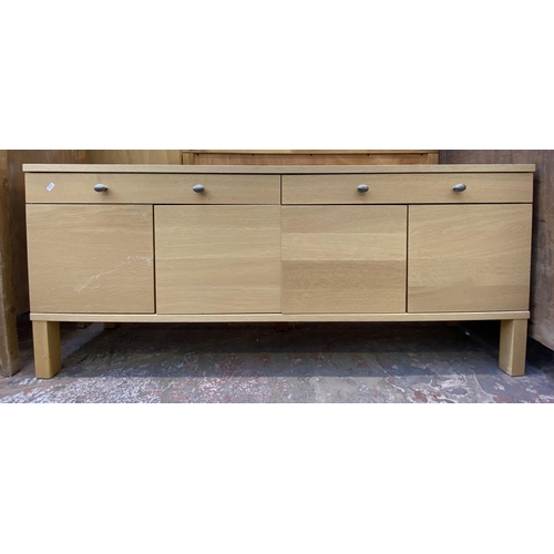 115 - A modern light oak sideboard with four cupboard doors and two drawers - approx. 67cm high x 156cm lo... 