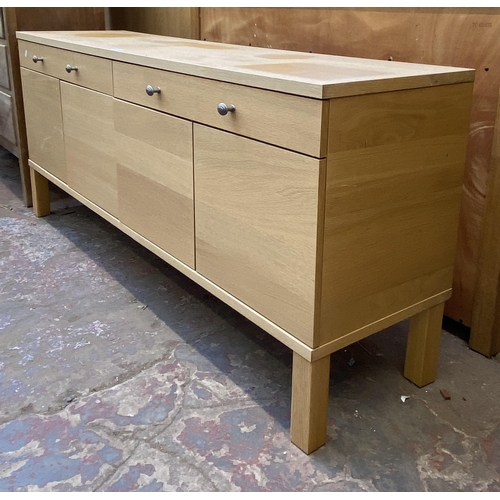 115 - A modern light oak sideboard with four cupboard doors and two drawers - approx. 67cm high x 156cm lo... 