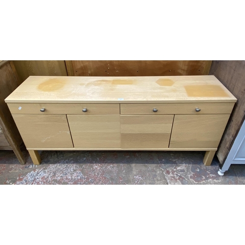 115 - A modern light oak sideboard with four cupboard doors and two drawers - approx. 67cm high x 156cm lo... 