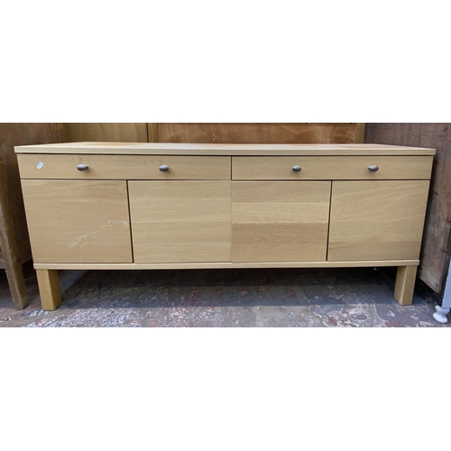 115 - A modern light oak sideboard with four cupboard doors and two drawers - approx. 67cm high x 156cm lo... 