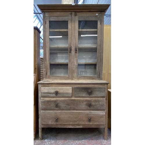 116 - A late 19th century pine bookcase with two long drawers, two short drawers, two glazed doors and thr... 