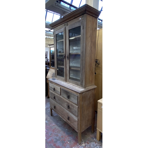 116 - A late 19th century pine bookcase with two long drawers, two short drawers, two glazed doors and thr... 