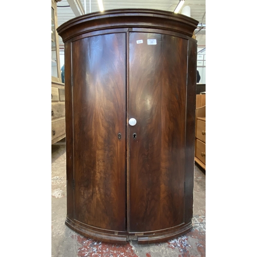 118 - A Georgian flamed mahogany bow fronted wall hanging corner cabinet - approx. 100cm high x 67cm wide ... 