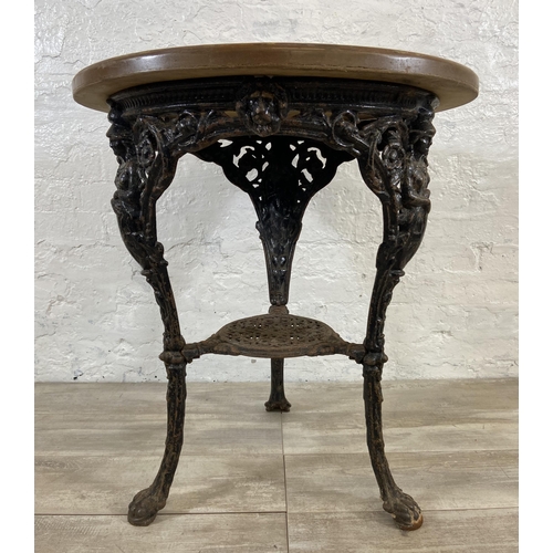 127 - A Victorian cast iron Britannia pub table with later added circular oak top - approx. 76cm high x 67... 