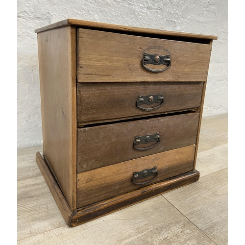 128 - An early 20th century miniature mahogany chest of four drawers - approx. 38cm high x 35.5cm wide x 3... 