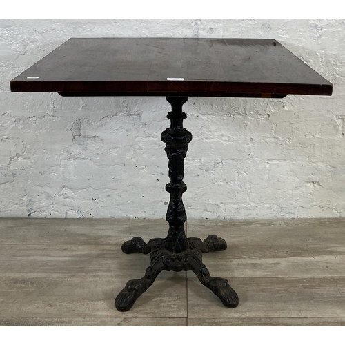 133 - A Victorian style cast iron pedestal bistro/pub table with later added oak top - approx. 71.5cm high... 