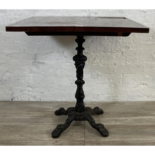 133 - A Victorian style cast iron pedestal bistro/pub table with later added oak top - approx. 71.5cm high... 