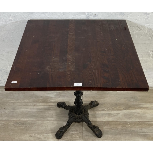 133 - A Victorian style cast iron pedestal bistro/pub table with later added oak top - approx. 71.5cm high... 