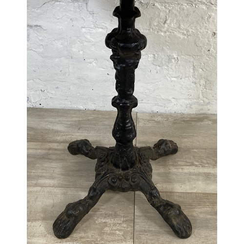 133 - A Victorian style cast iron pedestal bistro/pub table with later added oak top - approx. 71.5cm high... 