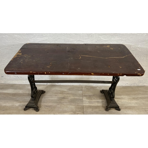 134A - A Coalbrookdale style cast iron twin pedestal garden table with later added stained pine top - appro... 