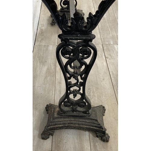 134A - A Coalbrookdale style cast iron twin pedestal garden table with later added stained pine top - appro... 