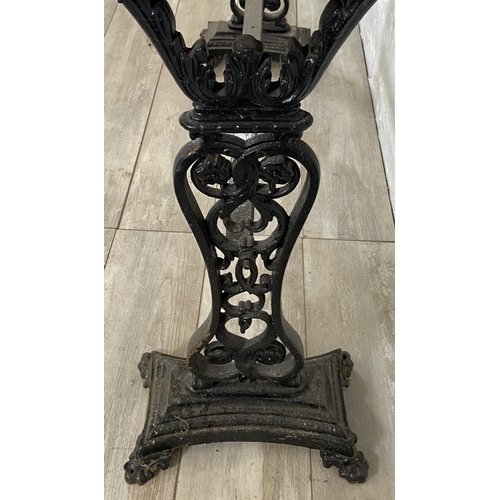 134A - A Coalbrookdale style cast iron twin pedestal garden table with later added stained pine top - appro... 