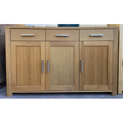 143 - A light oak sideboard with three lower cupboard doors and three drawers - approx. 82cm high x 130cm ... 