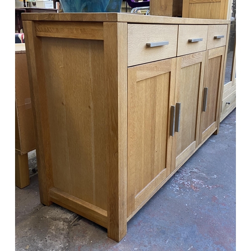 143 - A light oak sideboard with three lower cupboard doors and three drawers - approx. 82cm high x 130cm ... 