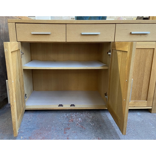 143 - A light oak sideboard with three lower cupboard doors and three drawers - approx. 82cm high x 130cm ... 