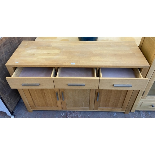 143 - A light oak sideboard with three lower cupboard doors and three drawers - approx. 82cm high x 130cm ... 