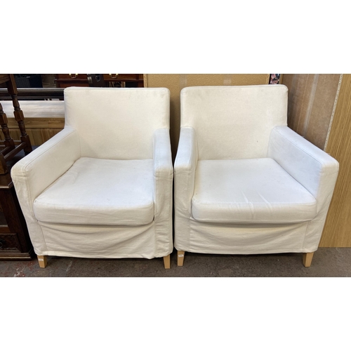 144 - A pair of white upholstered armchairs on tapered beech supports - approx. 81cm high x 70.5cm wide x ... 