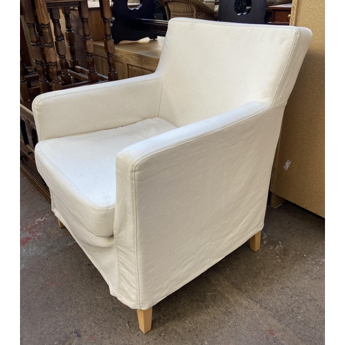 144 - A pair of white upholstered armchairs on tapered beech supports - approx. 81cm high x 70.5cm wide x ... 