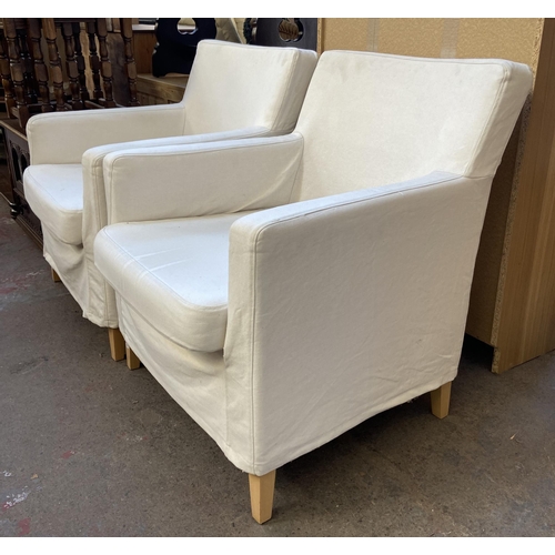 144 - A pair of white upholstered armchairs on tapered beech supports - approx. 81cm high x 70.5cm wide x ... 