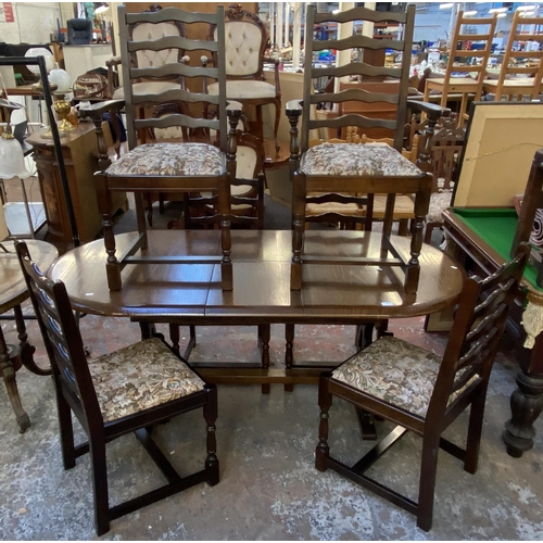 154 - An oak twin pedestal extending dining table with six ladderback dining chairs with tapestry upholste... 