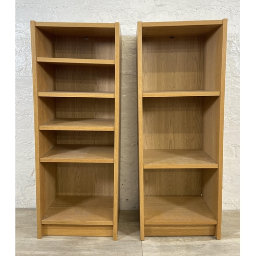 161 - A pair of IKEA Billy oak effect bookcases - approx. 106cm high x 40cm wide x 28cm deep