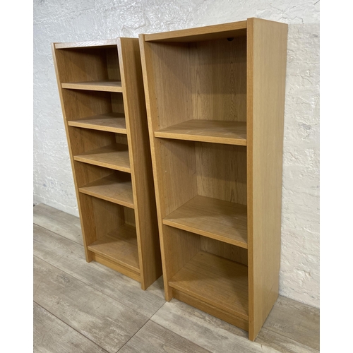 161 - A pair of IKEA Billy oak effect bookcases - approx. 106cm high x 40cm wide x 28cm deep