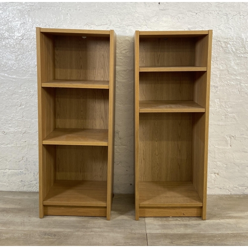 162 - A pair of IKEA Billy oak effect bookcases - approx. 106cm high x 40cm wide x 28cm deep