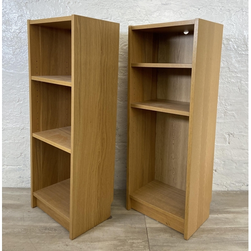 162 - A pair of IKEA Billy oak effect bookcases - approx. 106cm high x 40cm wide x 28cm deep