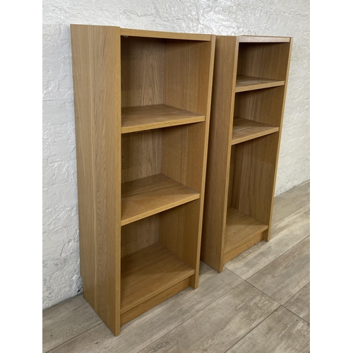 162 - A pair of IKEA Billy oak effect bookcases - approx. 106cm high x 40cm wide x 28cm deep