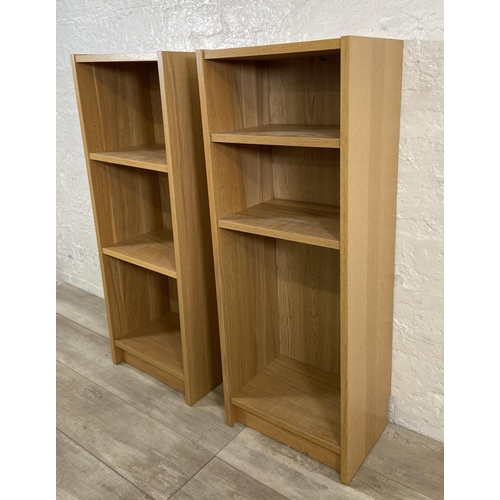 162 - A pair of IKEA Billy oak effect bookcases - approx. 106cm high x 40cm wide x 28cm deep