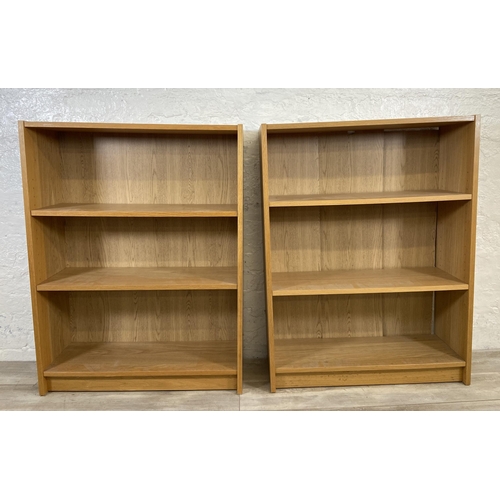 163 - A pair of IKEA Billy oak effect bookcases - approx. 106cm high x 80cm wide x 28cm deep