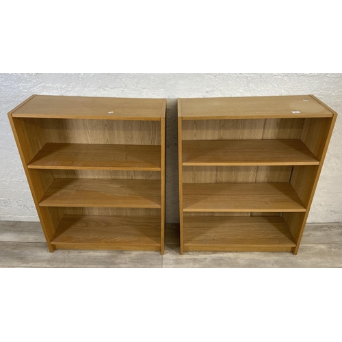 163 - A pair of IKEA Billy oak effect bookcases - approx. 106cm high x 80cm wide x 28cm deep