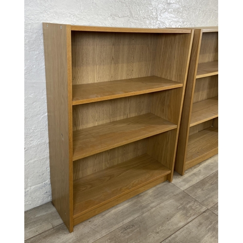 163 - A pair of IKEA Billy oak effect bookcases - approx. 106cm high x 80cm wide x 28cm deep