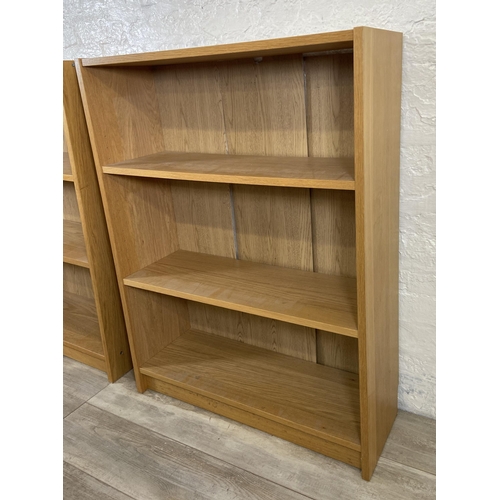 163 - A pair of IKEA Billy oak effect bookcases - approx. 106cm high x 80cm wide x 28cm deep