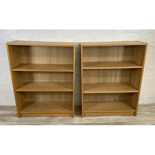 163 - A pair of IKEA Billy oak effect bookcases - approx. 106cm high x 80cm wide x 28cm deep