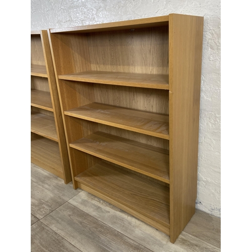 164 - A pair of IKEA Billy oak effect bookcases - approx. 106cm high x 80cm wide x 28cm deep