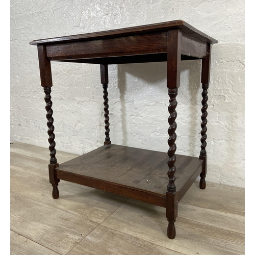 168 - A vintage oak two tier side table on barley twist supports