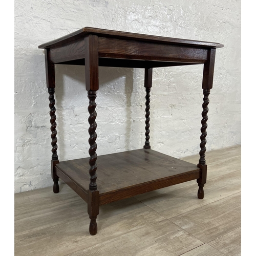 168 - A vintage oak two tier side table on barley twist supports