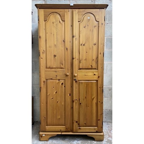 43 - A Ducal pine double wardrobe - approx. 192cm high x 98cm wide x 60cm deep