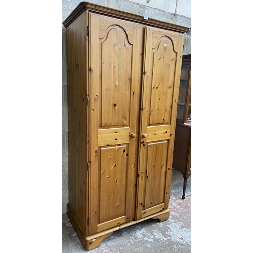 43 - A Ducal pine double wardrobe - approx. 192cm high x 98cm wide x 60cm deep