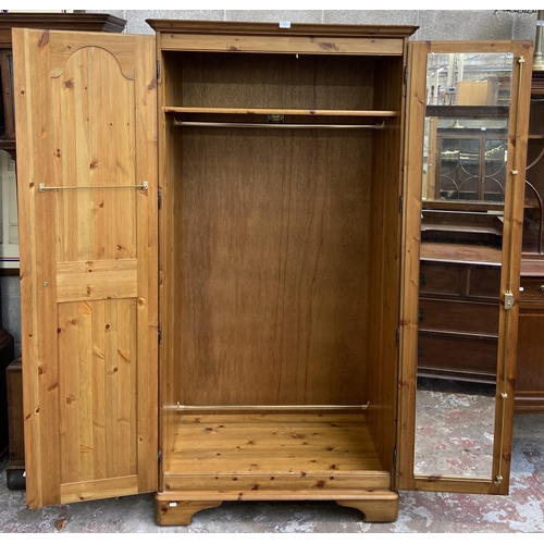 43 - A Ducal pine double wardrobe - approx. 192cm high x 98cm wide x 60cm deep