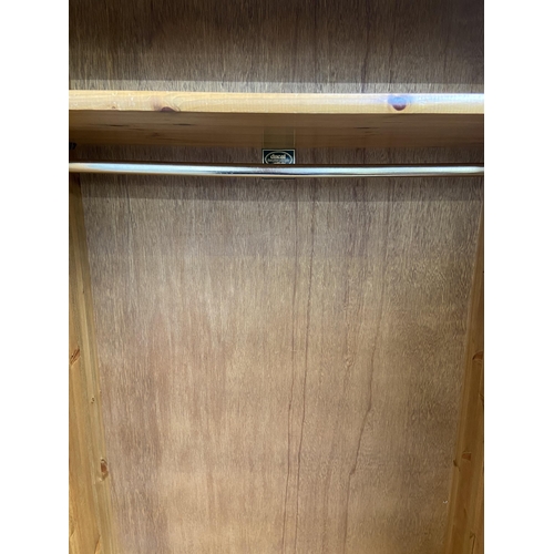 43 - A Ducal pine double wardrobe - approx. 192cm high x 98cm wide x 60cm deep