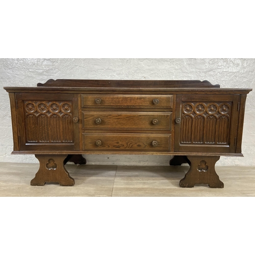 46 - A Gothic style carved oak dressing table - approx. 74cm high x 152cm wide x 45cm deep