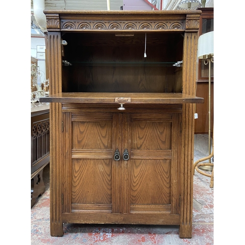 47 - A carved oak linenfold drinks cabinet with fitted interior - approx. 122cm high x 80cm wide x 48cm d... 