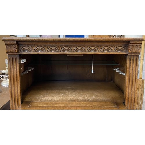 47 - A carved oak linenfold drinks cabinet with fitted interior - approx. 122cm high x 80cm wide x 48cm d... 