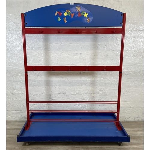 52 - A red metal and blue plastic child's coat rack on castors - approx. 154cm high x 120cm wide x 60cm d... 