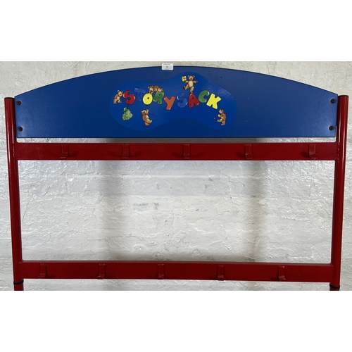 52 - A red metal and blue plastic child's coat rack on castors - approx. 154cm high x 120cm wide x 60cm d... 