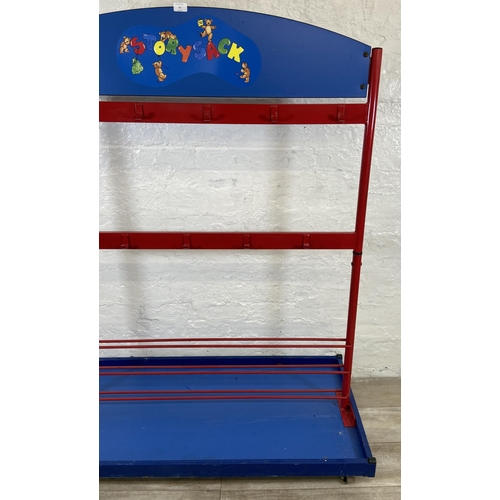 52 - A red metal and blue plastic child's coat rack on castors - approx. 154cm high x 120cm wide x 60cm d... 