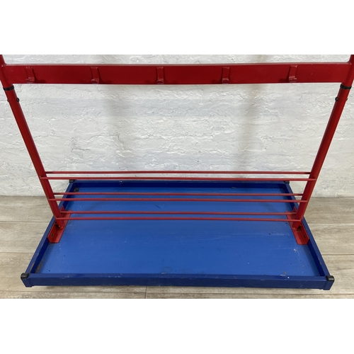 52 - A red metal and blue plastic child's coat rack on castors - approx. 154cm high x 120cm wide x 60cm d... 