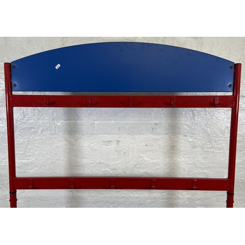 52 - A red metal and blue plastic child's coat rack on castors - approx. 154cm high x 120cm wide x 60cm d... 